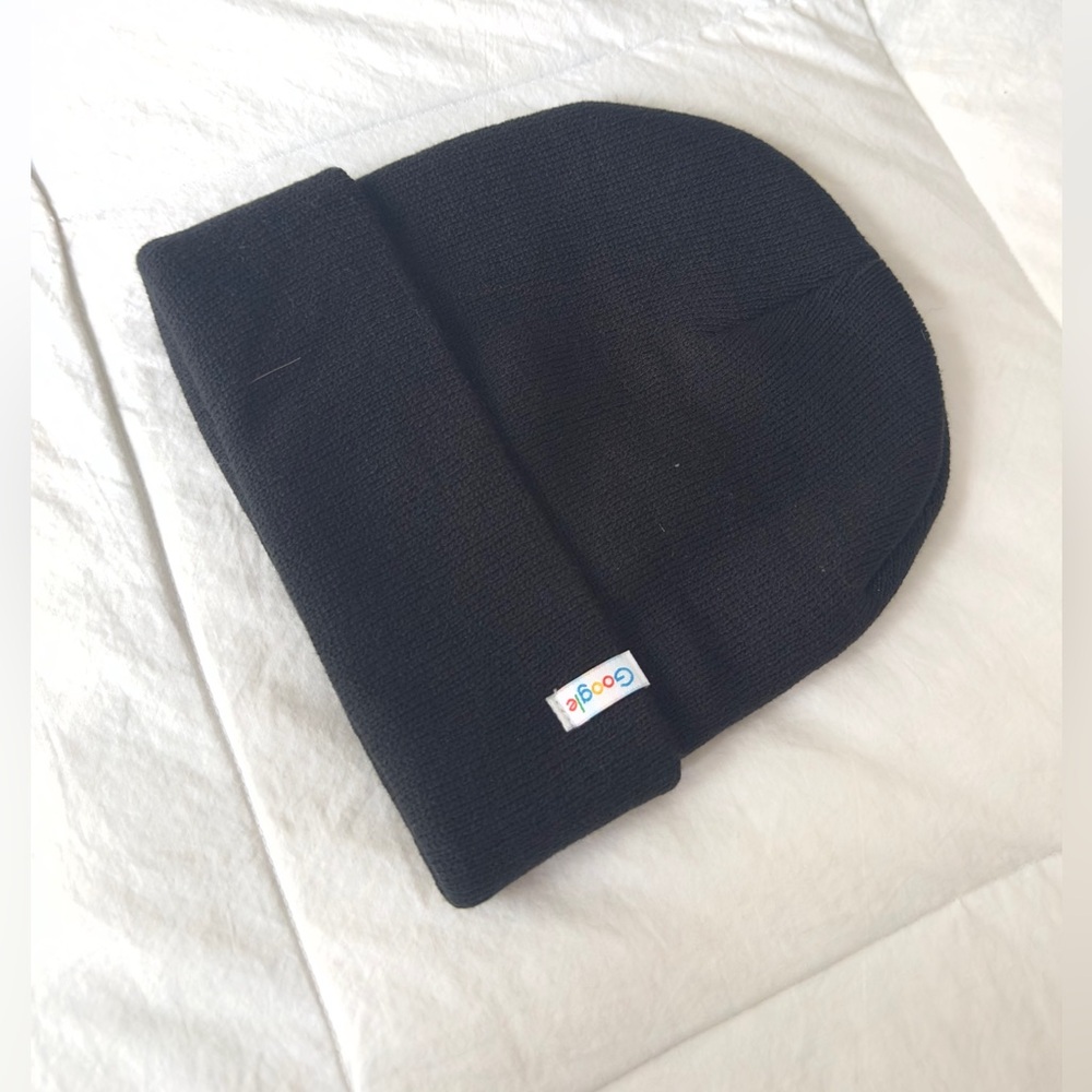 Black winter cap with logo never worn.